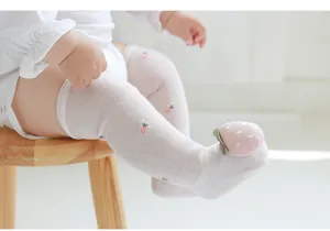 Infant summer mesh cotton over-the-knee socks detail view, featuring cute 3d strawberry doll.