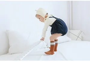 Comfortable combed cotton baby knee-high socks with anti-slip design for toddlers.