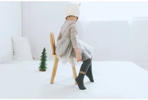 Detail view of baby ribbed tights showing soft cotton texture and comfortable fit in scene details.