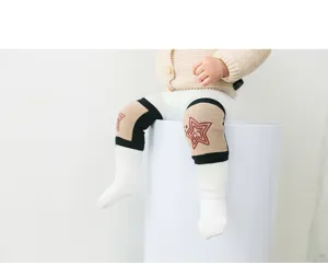Baby knee pads detail shot showing soft cotton material and anti-collision star embroidery design.