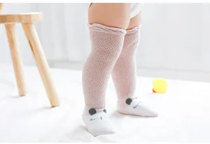 Detailed view of breathable mesh over-the-knee baby socks in soft pink with cute animal design.