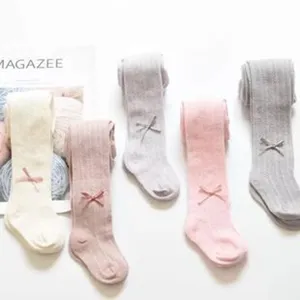 Detailed view of children mesh thin tights with cute bow design, soft cotton fabric.