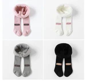 Detailed view of thick fleece-lined kids tights featuring cute bow decor in multiple colors.