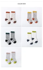 Detailed view of thick knit baby socks with anti-slip soles in various colorful combinations.