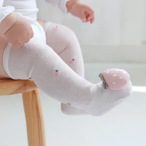 Cute baby over-the-knee mesh socks with 3D strawberry design for summer protection.