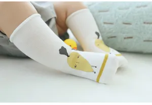 Close-up detail of cute infant long socks with fun cartoon radish print for babies.