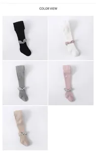 Detail view of the combed cotton baby tights with cute wing and bow accents in multiple colors.