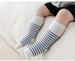 Newborn baby striped knee-high cotton socks detail showcasing comfortable ribbed cuff design.