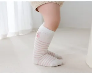 Infant baby knee-high socks detail view, featuring cute pink striped pattern and animal embroidery.