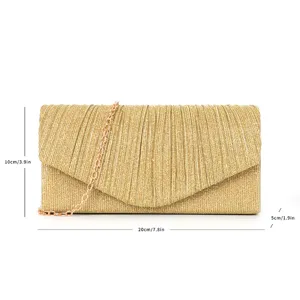 Detailed view of the gold glitter pleated evening clutch bag with chain strap for party.