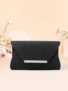 Detailed view of black glitter envelope evening clutch with elegant metallic front bar.