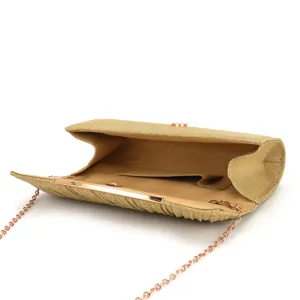 Close-up detail of a gold glitter evening clutch bag with pleated surface and chain.