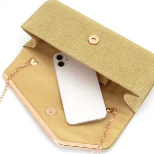 Gold glitter evening clutch bag detail showing interior capacity with phone and metal chain strap.