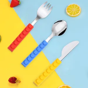 Stainless steel baby cutlery set with silicone building block handles, fork, spoon and knife.