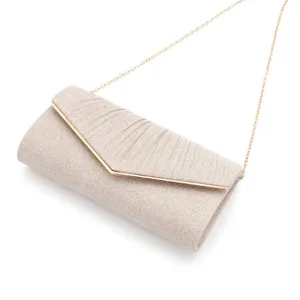 Exquisite detail view of shimmering champagne evening clutch bag with V-shaped flap design.