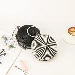 Woven round crossbody bag, handmade straw clutch with metallic ring handle and chain strap for women.