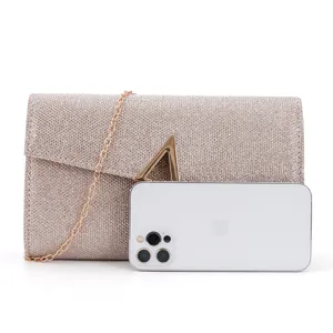 Glitter clutch bag detail shot showing sparkling texture, metal chain and sleek design.