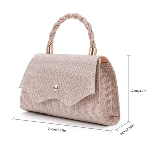 Detailed view of a sparkling glitter evening handbag with twisted handle and metal clasp closure.