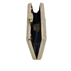 Rhinestone clutch bag interior detail, luxurious gold sparkle evening bag with chain strap.
