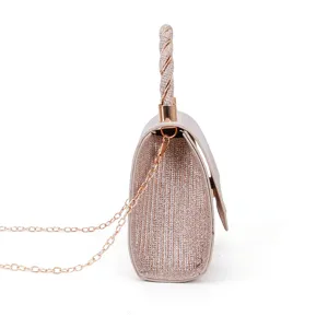 Side detail view of sparkling glitter evening bag with chain strap and elegant woven top handle.
