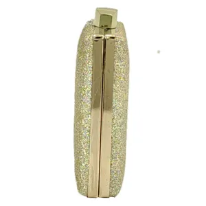 Gold glitter clutch side detail, metallic frame evening bag for party and wedding events.
