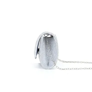Side view of a silver glitter evening clutch bag featuring a delicate metal chain strap.