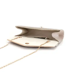Details of glittering evening clutch bag with golden chain strap and v-shaped flap design.
