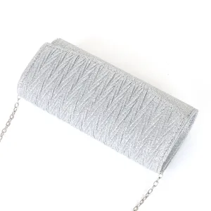 Silver glitter evening clutch bag detail showing pleated texture and chain strap closeup.