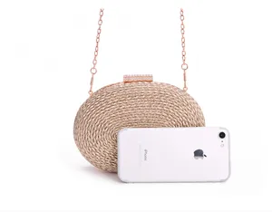 Detailed view of fashionable woven evening clutch bag with sparkling clasp and chain.