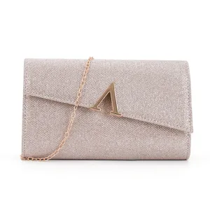 Glitter evening clutch bag detail showing metallic letter lock and chain strap for women.