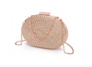 Detailed view of the elegant rose gold woven oval evening clutch bag with chain strap.