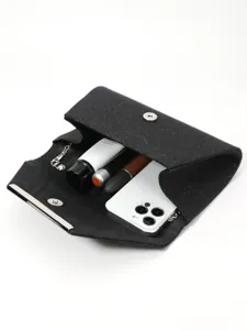 Black glitter evening clutch bag interior capacity detail with phone and cosmetics display.