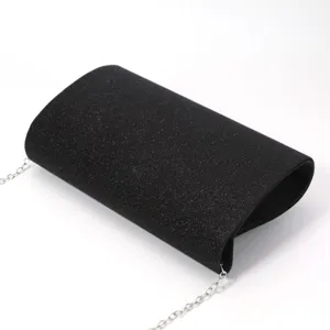 Close-up detail of the elegant black glitter evening clutch bag with fine silver chain.