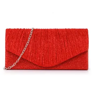 Red glitter evening clutch bag detail view, showing the sparkling fabric and pleated flap.