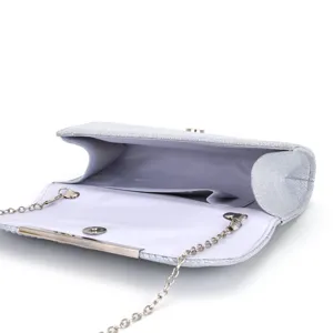 Close-up detail of the silver glitter evening clutch bag interior and metallic chain strap.