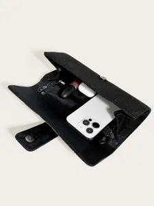 Sparkling black rhinestone evening clutch bag detail showing interior capacity for essentials.