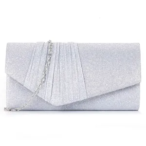 Silver glitter evening clutch bag detail showing pleated flap design and metallic chain.