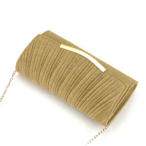 Gold pleated evening clutch bag detail showing metallic bar closure and delicate chain strap.