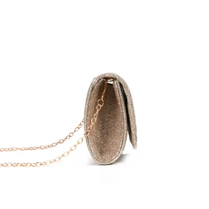 Detailed side view of sparkling glitter clutch bag with elegant chain strap for evening events.