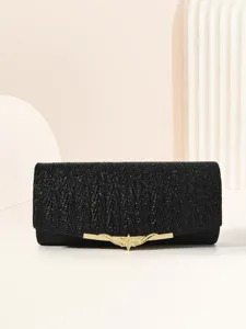 Black glitter clutch bag detail, gold metal clasp accessory, elegant evening party accessory view.