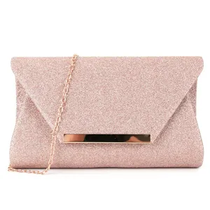 Rose gold glitter clutch bag detail showing metallic bar and fine chain strap close-up view.