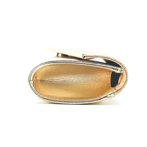 Gold glitter evening clutch bag detail, side view showing PU leather and structured bottom shape.
