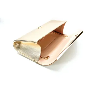 Close-up detail of the elegant gold PU leather evening clutch bag with chain strap and clasp.