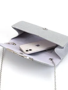 Silver glitter evening clutch bag for women with chain strap and spacious interior design.