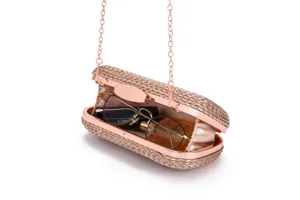 Rose gold woven evening clutch bag featuring a metallic frame and elegant chain strap detail.