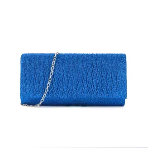 Blue glitter clutch bag detail, evening party shoulder handbag with silver chain strap.