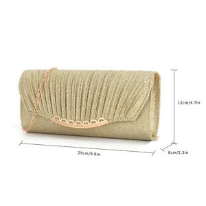 Elegant gold glitter clutch bag detail showing pleated texture and compact dimensions 25x12x6cm.