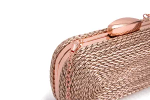 Close-up view of the rose gold woven clutch bag showing metallic frame and exquisite clasp details.