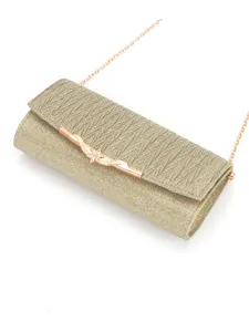 Detail view of gold pleated evening clutch bag featuring metal clasp and chain strap.