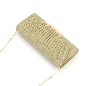 Closeup view of the gold glitter clutch bag showing pleated fabric texture and metallic clasp.